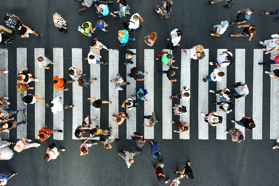 Picture from above of a crowd of people in a crosswalk